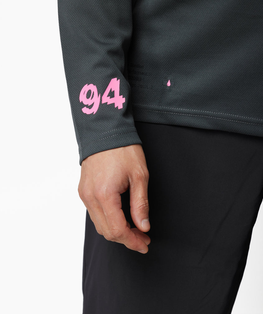 Grey long sleeve mountain bike jersey on a trail rider